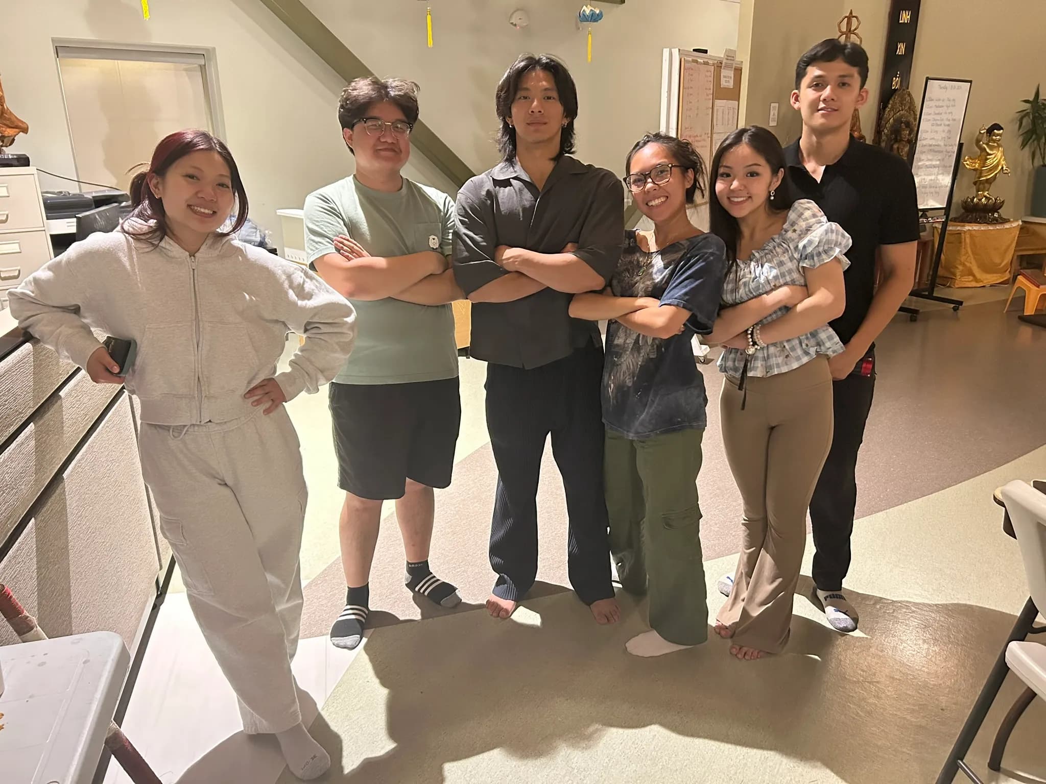 Six friends posing indoors at the meditation centre.